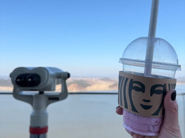 Holding a disposable Starbucks Coffee cup in front of binoculars at Aegibong Starbucks, the closest Starbucks to the DMZ