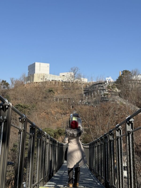A girl taking a selfie on the Black Suspension Bridge at Aegibong Peace Eco Park in Gimpo