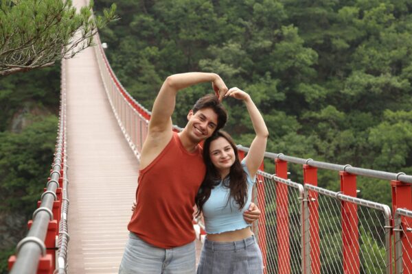 Couple taking a photo on DMZ Gamaksan Red Suspension Bridge
