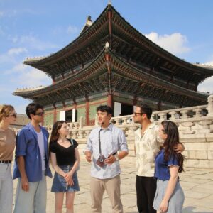 One of VIP Travel's tour guides introducing Geunjeongjeon in front of the Throne Hall to a tour group at Gyeongbok Palace in Seoul