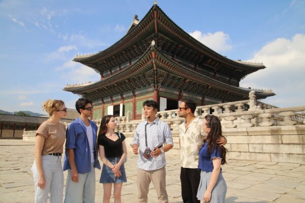 One of VIP Travel's tour guides introducing Geunjeongjeon in front of the Throne Hall to a tour group at Gyeongbok Palace in Seoul