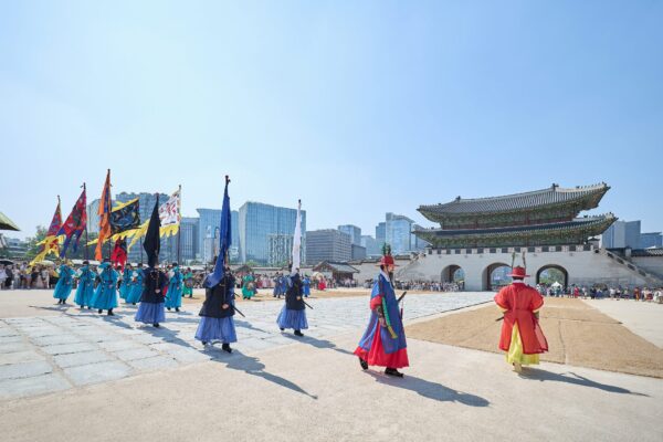 A photo of the Changing of the Guard Ceremony taking place at Gyeongbok Palace's Gwanghwamun Gate