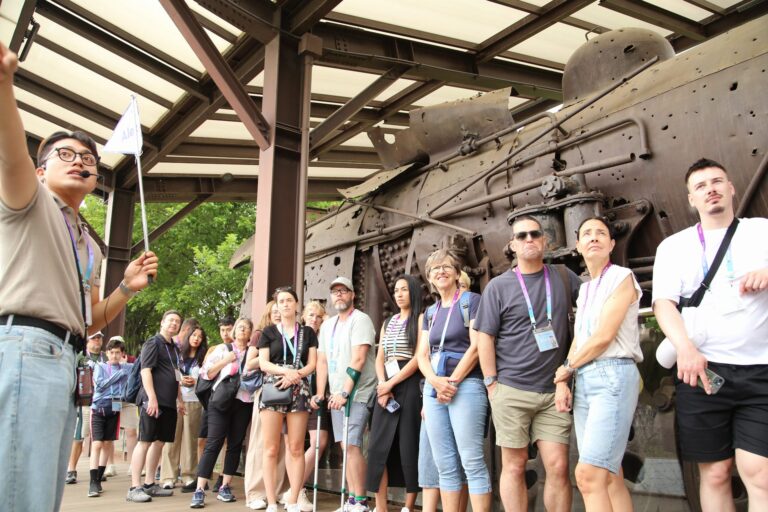 A tour guide introducing the DMZ Iron Horse train relic at Imjingak Jangdan Station in Paju