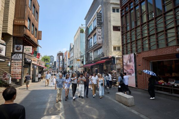 A tour group walking up the famous Insadong culture and art Street in downtown Seoul