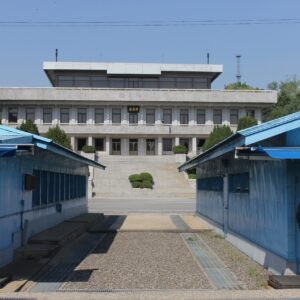 South Korean JSA Border Guards standing in front of the Military Demarcation Line with North Korea's Panmungak building in the background