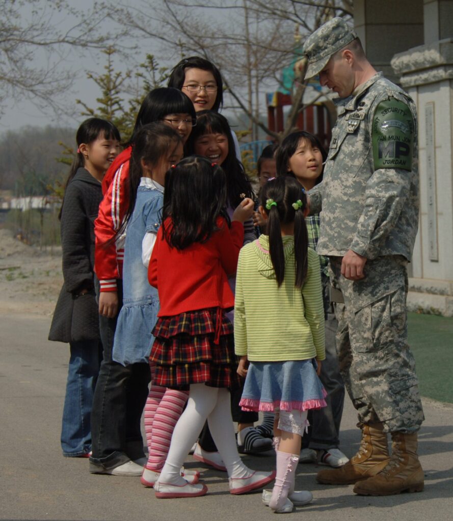 South Korean Daeseong-dong elementary students talking and laughing with a US Joint Security Area MP border guard
